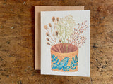 Greeting card with floral design on a wooden surface